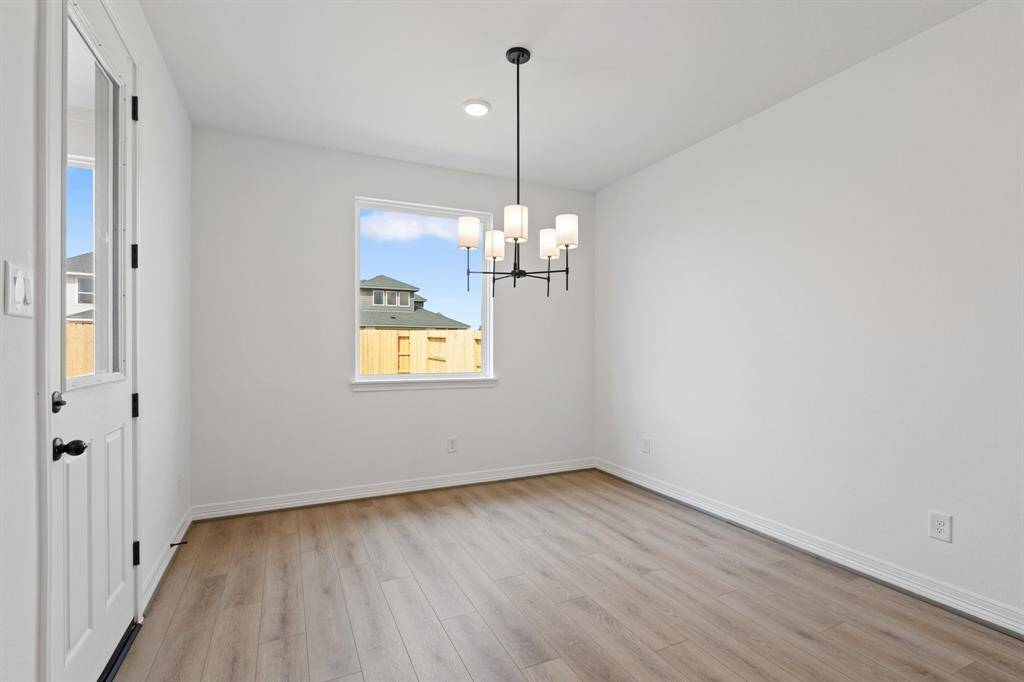 With an abundance of natural light streaming through the windows, the breakfast nook is bathed in a sunny glow, creating the perfect atmosphere to enjoy your morning coffee or a family breakfast.