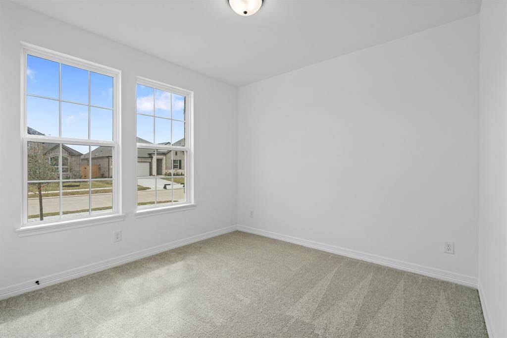 Your secondary bedroom features plush carpet, fresh paint, closet, and a large window that lets in plenty of natural lighting.