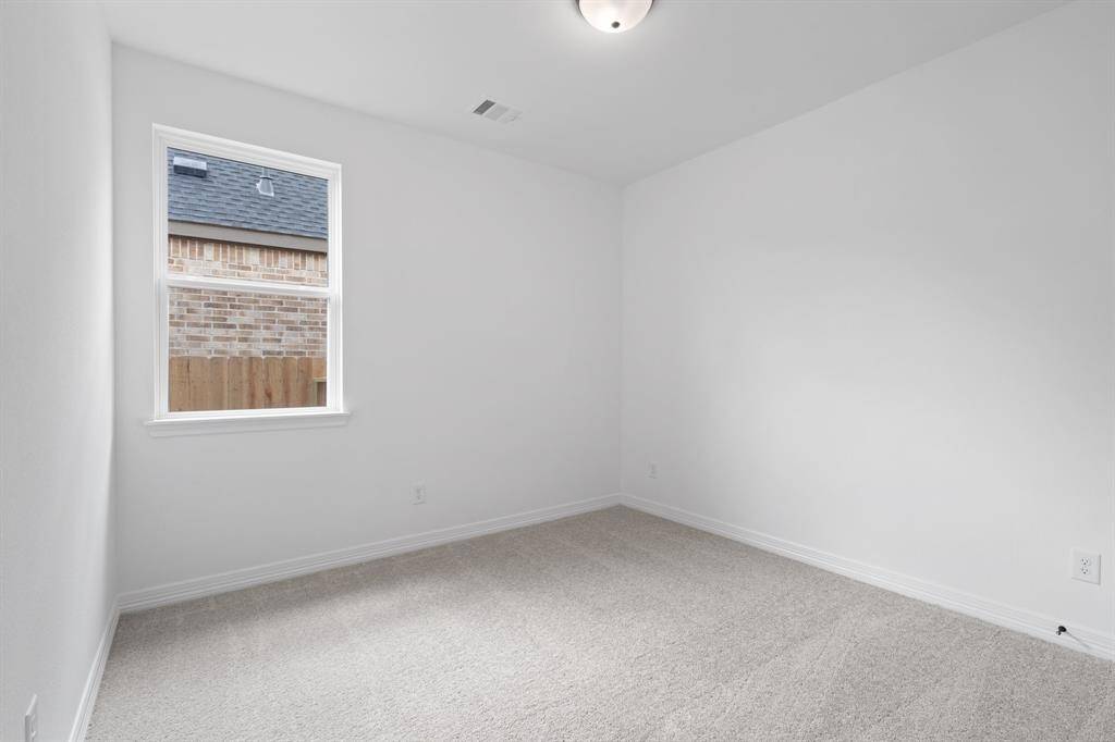 Your secondary bedroom features plush carpet, fresh paint, closet, and a large window that lets in plenty of natural lighting.