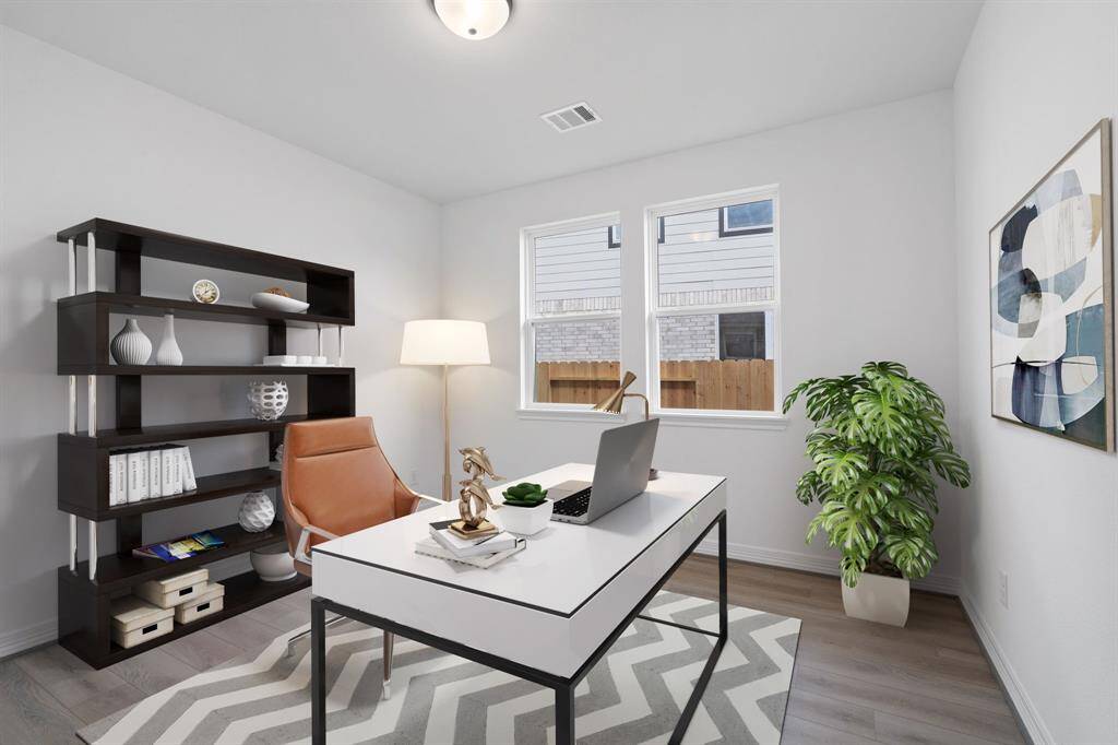 The home office features beautiful floors, large windows that give a fresh feel, this space promotes focus and creativity. Photo is virtually staged