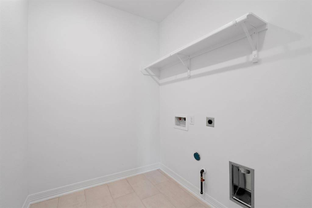The laundry room layout is carefully planned for optimal workflow with designated areas for washing, drying, and storing.