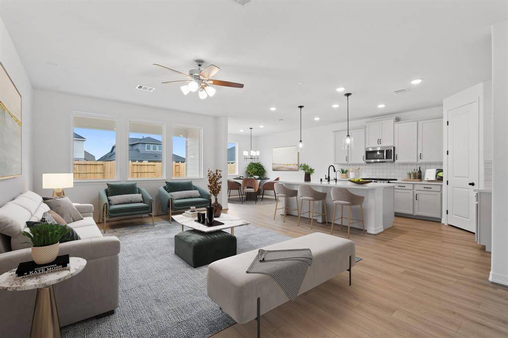 This home boasts a spacious open concept layout that combines the best of modern design and comfort for everyday living. Photo is virtually staged