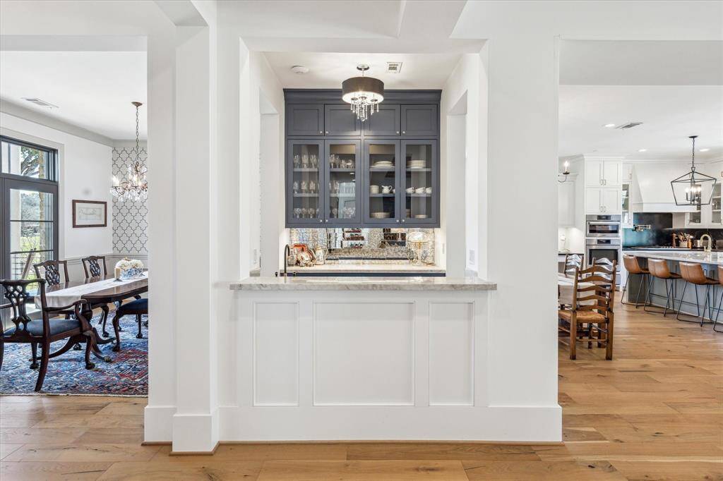 Built for hospitality, the owners thought of it all with this centrally located wet bar that sets a swanky tone in this transitional ranch style home.