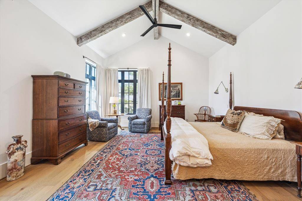 Owner’s retreat located downstairs features dramatic cathedral ceiling with distressed wood beams.  Corner exposures offer full view of the backyard.