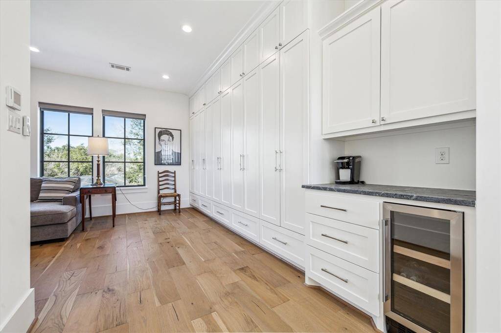 You will never run out of storage with walls of built-ins.  Owner even customized a gift wrap cabinet.  Wonderful serving area with soapstone counter for coffee bar ahd built in fridge below.