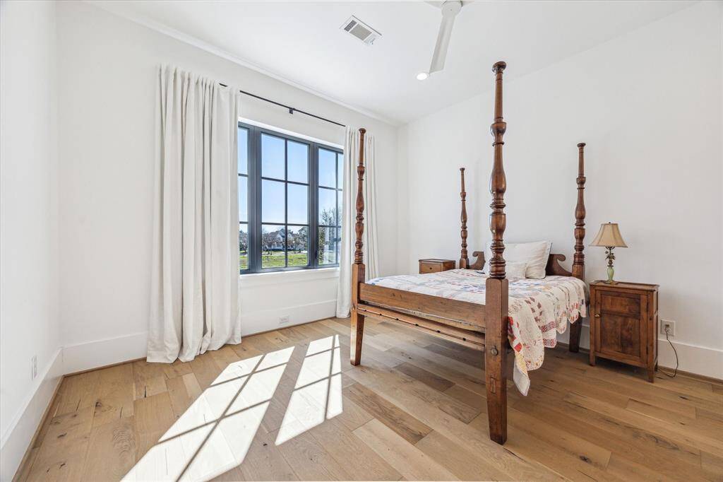 One of two upstairs bedroom with French oak hardwoods, recessed lights, ceiling fan and views over the front yard.