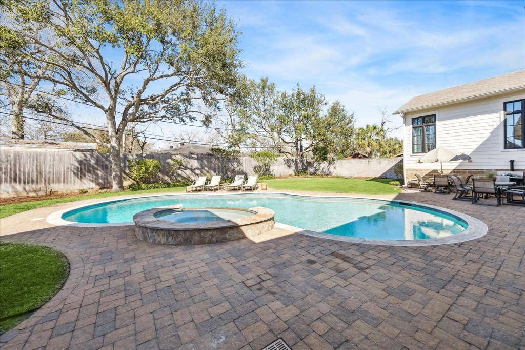 Inviting pool and spa with brick patio.