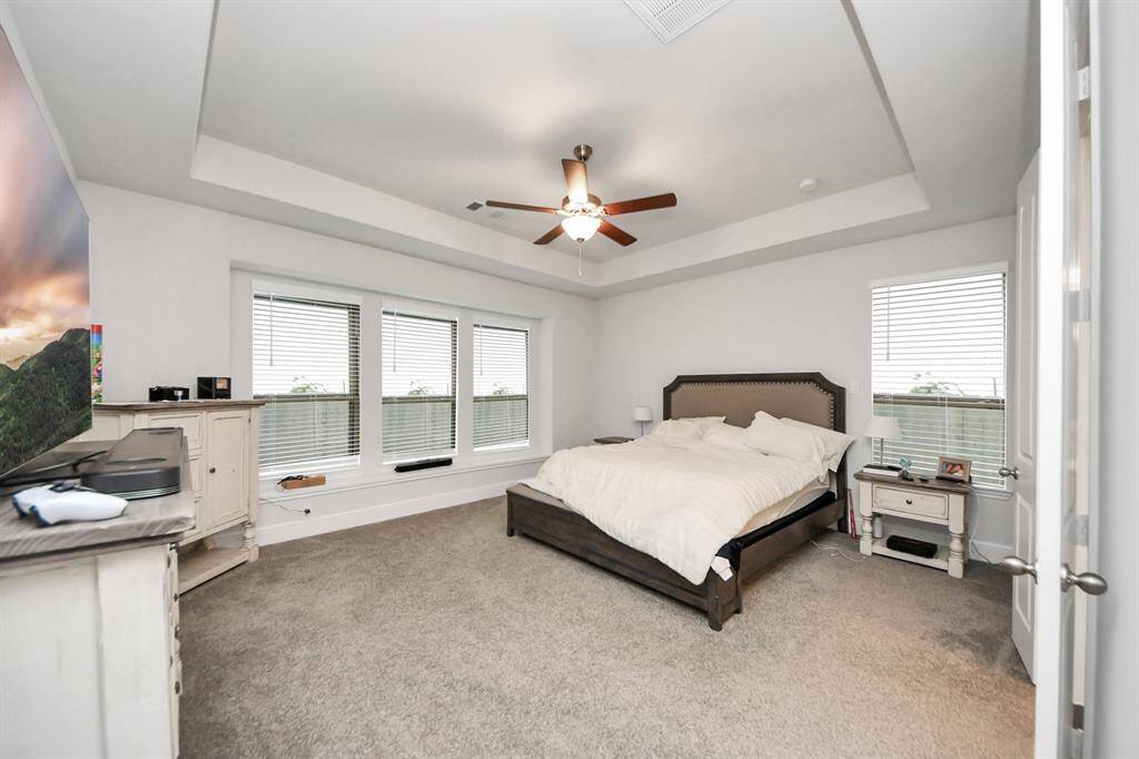 This beautifully appointed primary suite offers high ceilings and an abundance of natural light, making it feel open and inviting. With plenty of space, it’s an ideal spot to retreat and recharge in complete comfort.