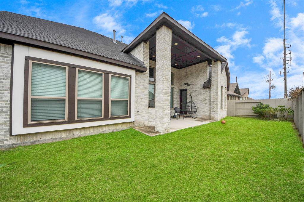 Fully fenced and manicured backyard.