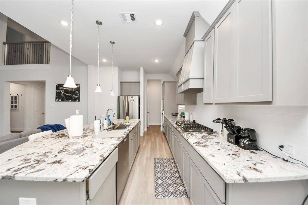 Another view of the large kitchen with tons of counterspace and storage. The kitchen is also in the middle of the home, allow for a quick view of all activities in the home.