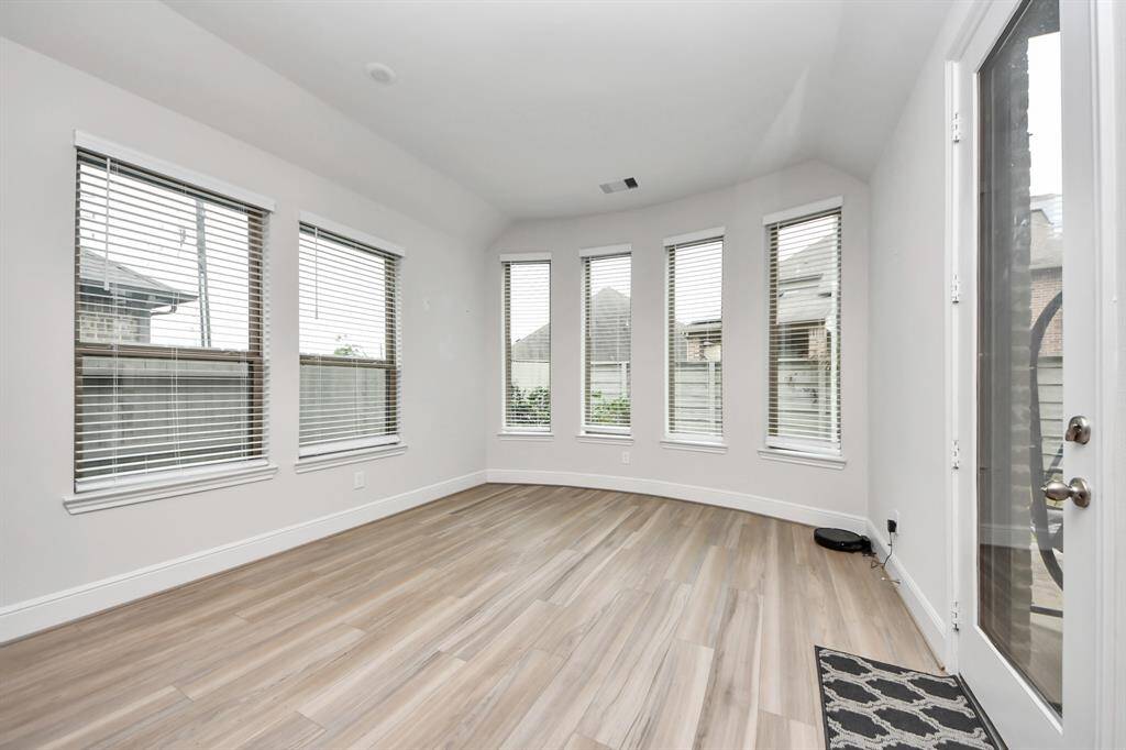 The dining area features multiple tall windows, filling the space with natural light—perfect for enjoying your morning cup of coffee as the sun greets you.