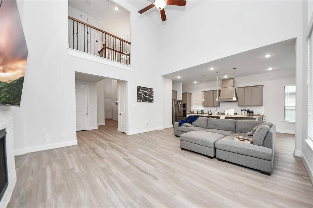 Living room with high ceilings and open floor plan. Plenty of natural light.