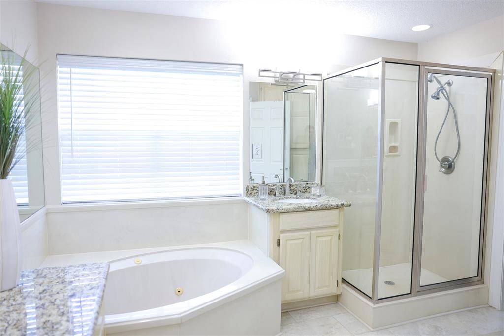 jetted tub, separate shower and his/her vanity