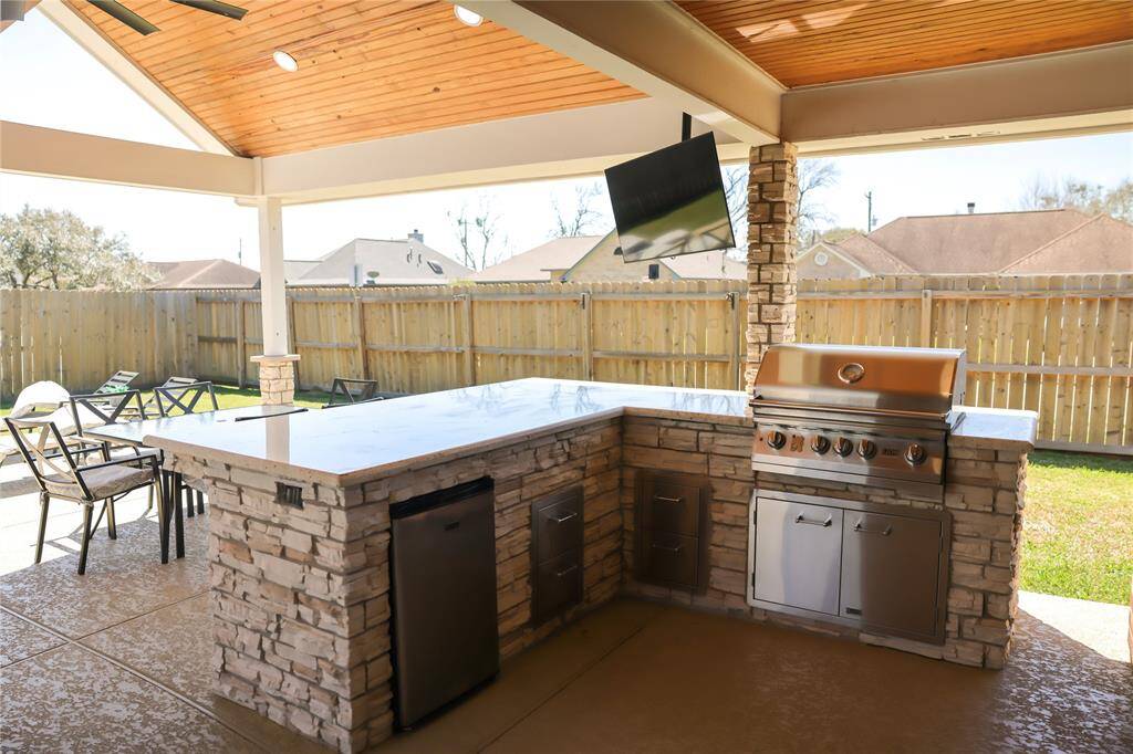 Grill is connected to gas line from the house, no need for propane tank.