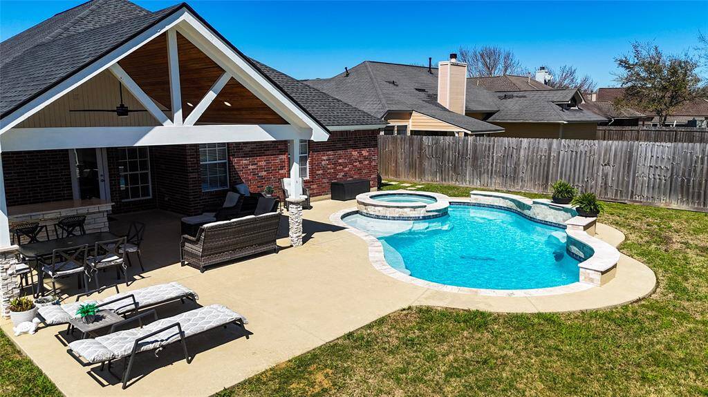 Your outdoor oasis. An 18x20 Patio area with an outdoor kitchen, bar area, heated pool, spa, and water features.