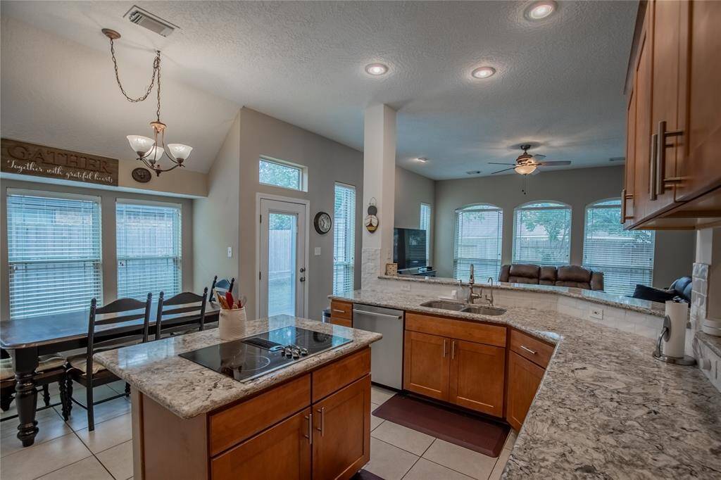 Gorgeous kitchen features updated soft-close cabinets, quartz counters, and stainless appliances