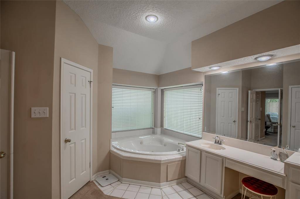 Primary bath boasts large closets and jetted tub