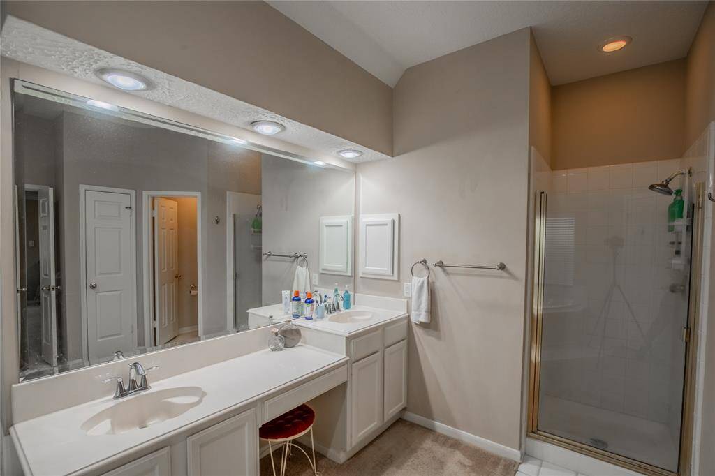High low vanities with double sinks and separate shower in Primary Bath