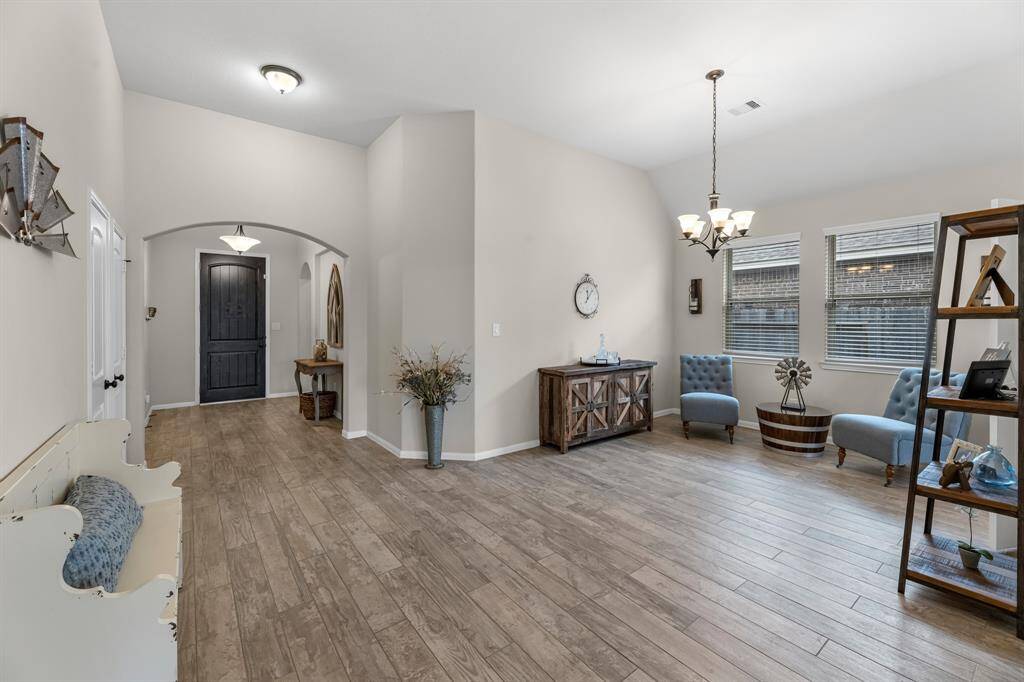 Looking back into the front door entryway. To the left of the front door there are two guest bedrooms and a full bath between them