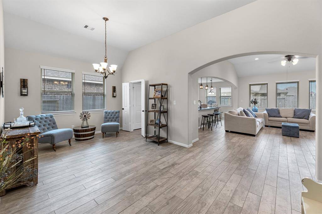 Wonderful natural light, wood-grained ceramic tile, large formal dining area could accommodate a massive farm table. As you can see, it can also serve as a lounge area, open office, and game area.