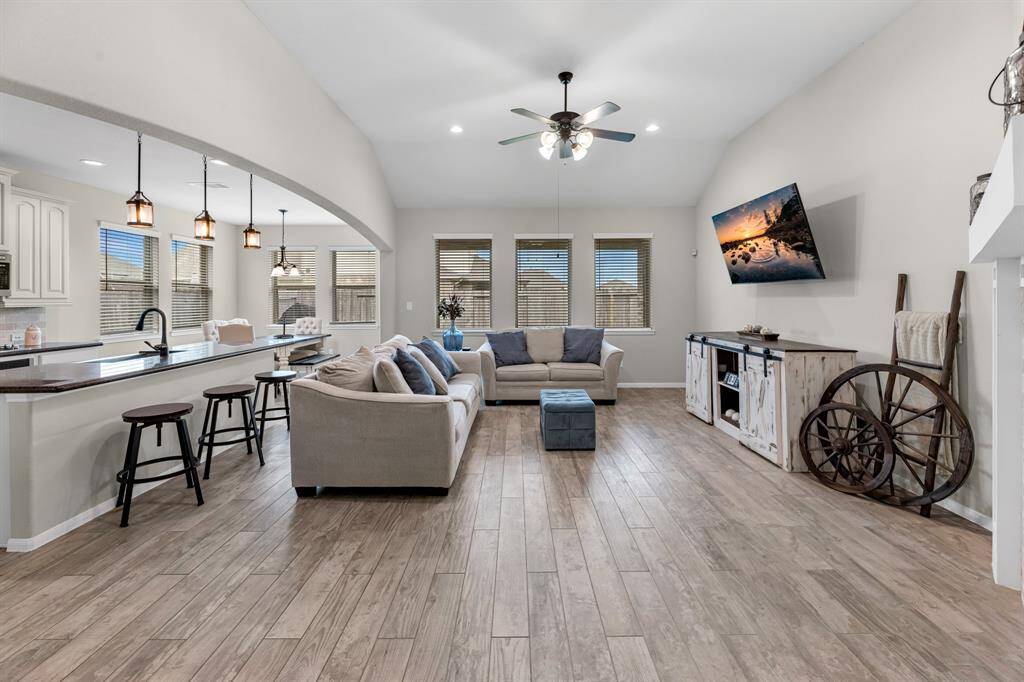 Charming living room with high ceilings, ceramic tile floors, and recessed lighting