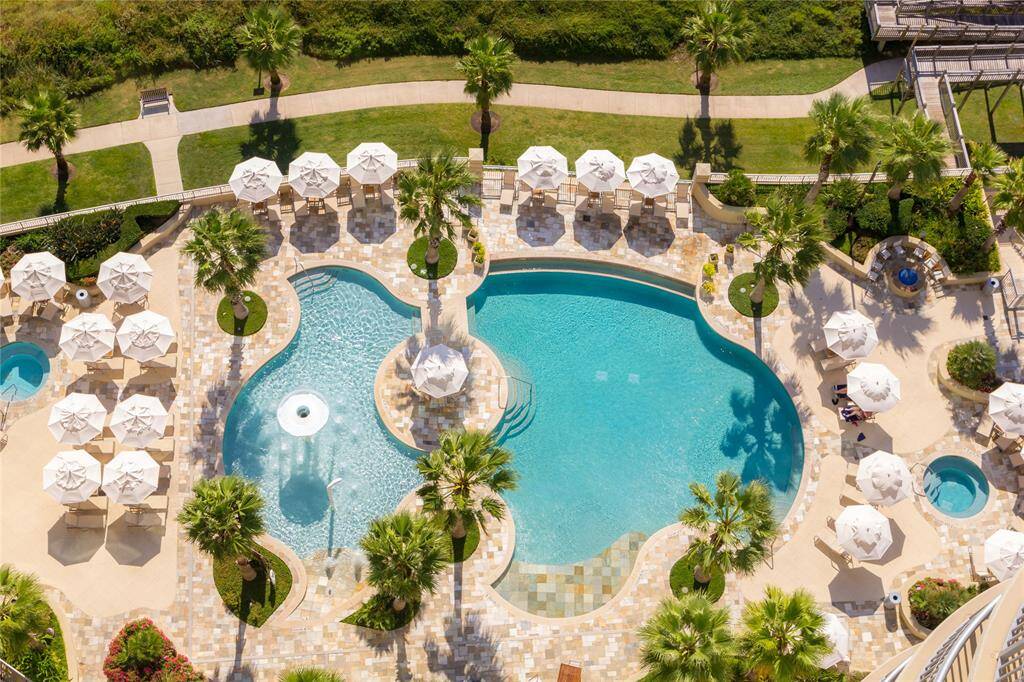 Pool deck at Palisade Palms offers a delightful retreat with a pair of heated pools, two relaxing hot tubs, and a cozy fire pit—a perfect blend of luxury and comfort!
