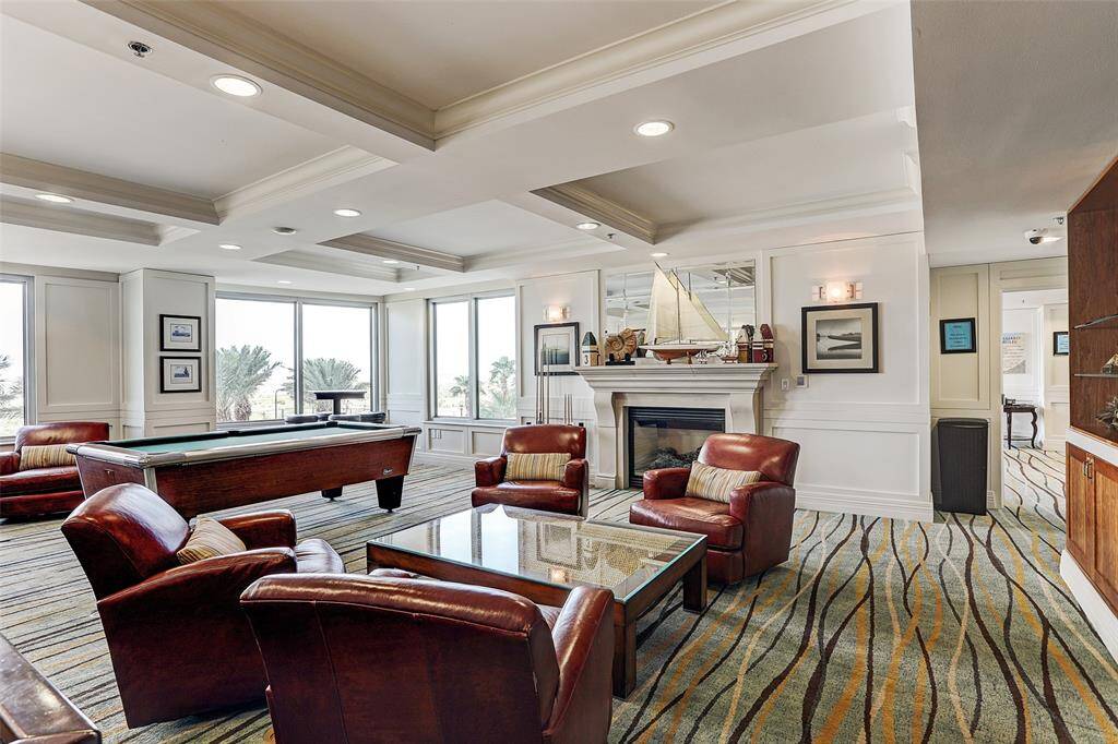 An additional game room awaits you, complete with a pool table and shuffleboard table, along with plenty of comfortable seating for everyone's enjoyment.