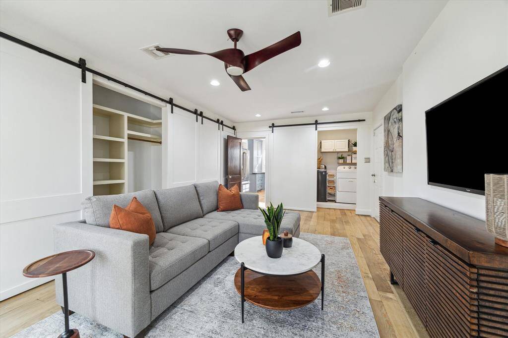 Look at all of this storage in this versatile flex space area. Sliding barn doors conceal the laundry area and ample closet space.  It is great for a family room or could be a third bedroom.