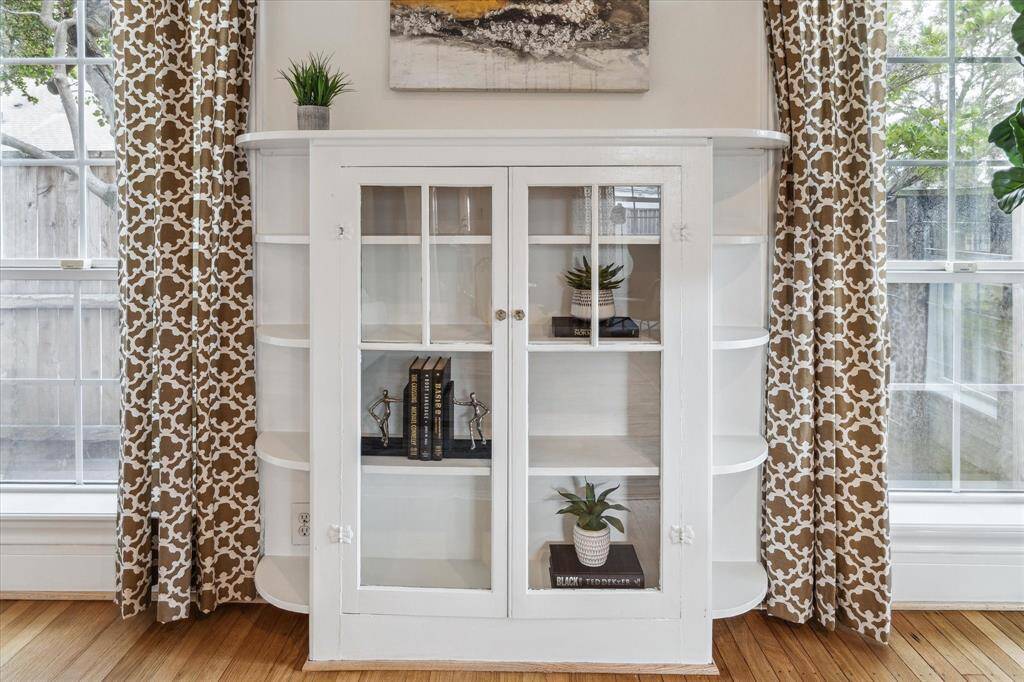 The glass front storage cabinet in the living room is just one of the period architectural details original to the house.