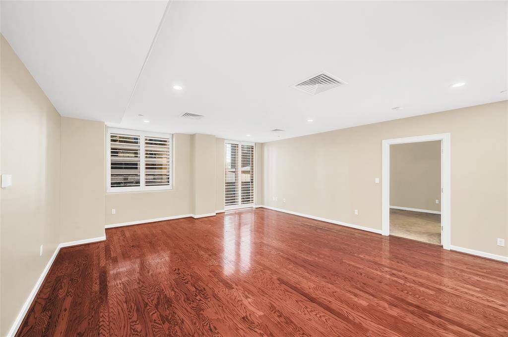 The Living Room is approximately 22'x18'* allowing for large furniture pieces and flexibility in furniture arrangement. All windows in home have plantation shutters. Open doorway leads into Primary Suite. Recessed lighting overhead. *Buyer to verify dimensions.