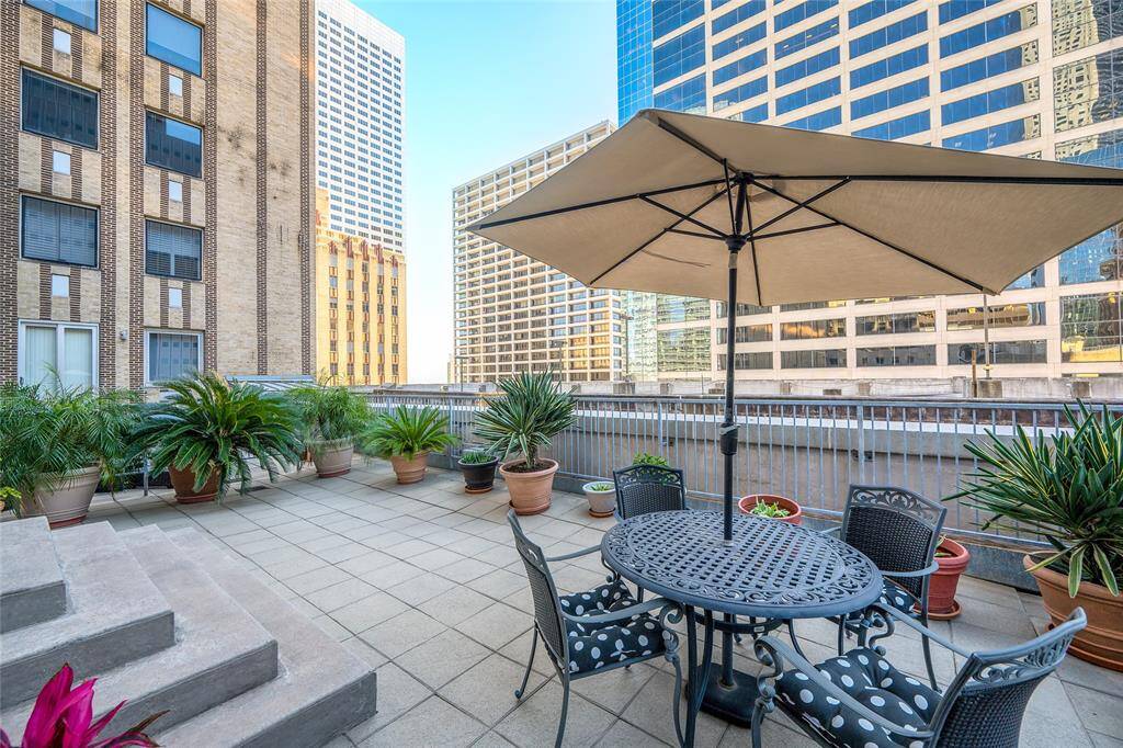 Daytime view of the over 500 sq/ft private terrace of Commerce Towers #1213. The building only has a handful of private terraces and this is one of the few that is on a high enough floor to clear the building next door allowing fantastic views.