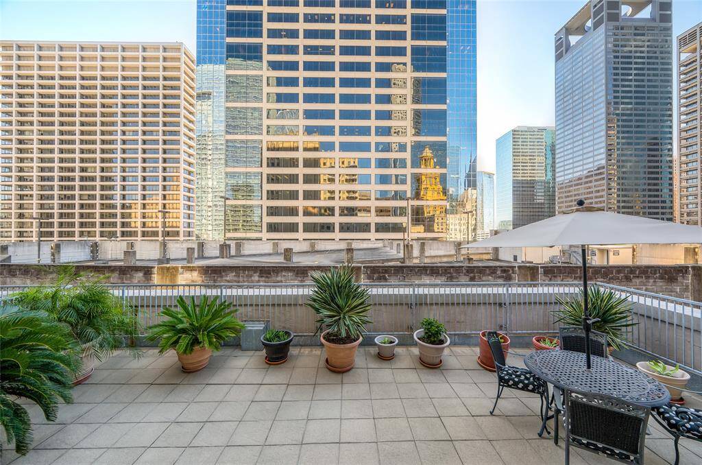 The view standing at top of terrace steps as you exit through the sliding door of home!  All pots, plants and furniture on terrace included with sale.  Notice you see the reflection of numerous other buildings in the glass facade of the facing building!