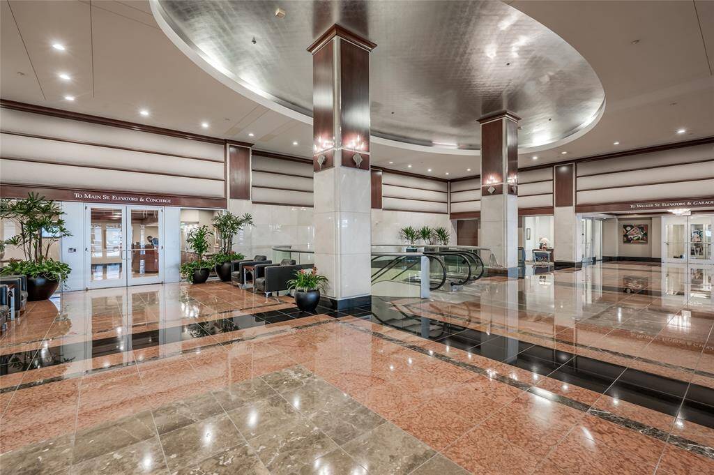 The Building Lobby of 914 Main shows the escalators leading down to Downtown's 7 mile tunnel system, connecting you to most of Downtown's major buildings. The tunnels have restaurants, shops & more! Through the secured double doors seen to left is Commerce Tower's Resident’s Lobby with concierge!