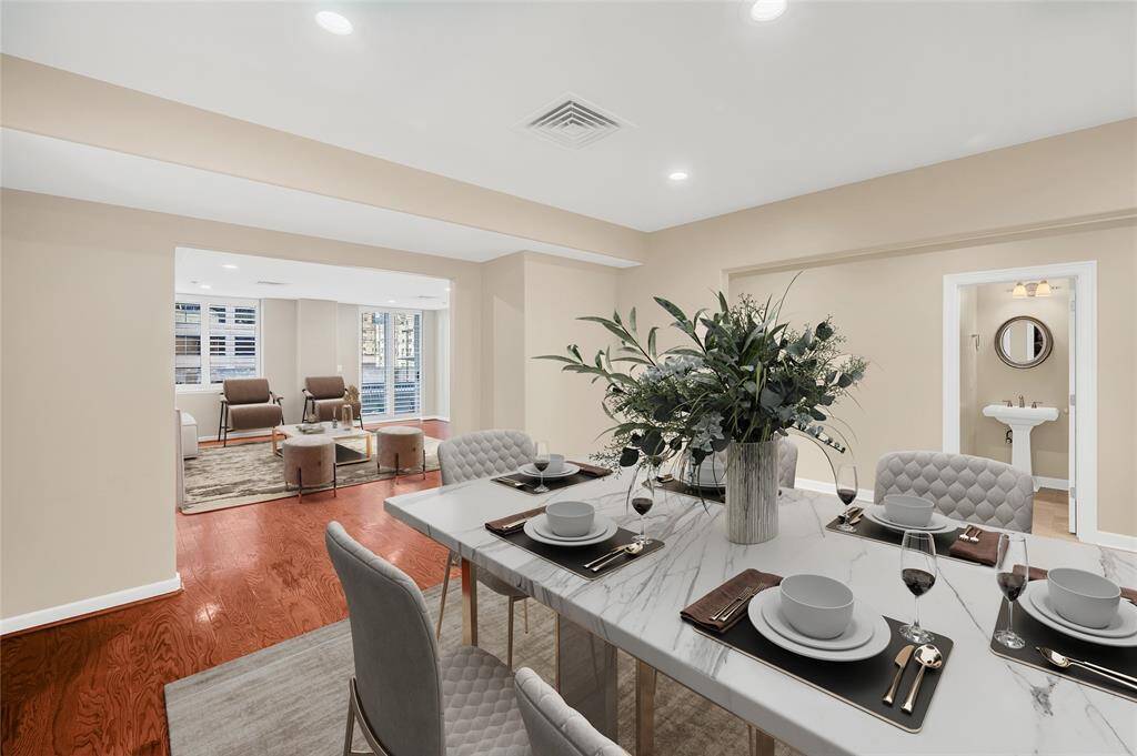 The interior offers an open Living/Dining/Entry floor plan with oversized rooms. Engineered wood in Living & Dining and marble Entry Hallway. Half Bath is located off of Entry Hallway. PHOTO VIRTUALLY STAGED.