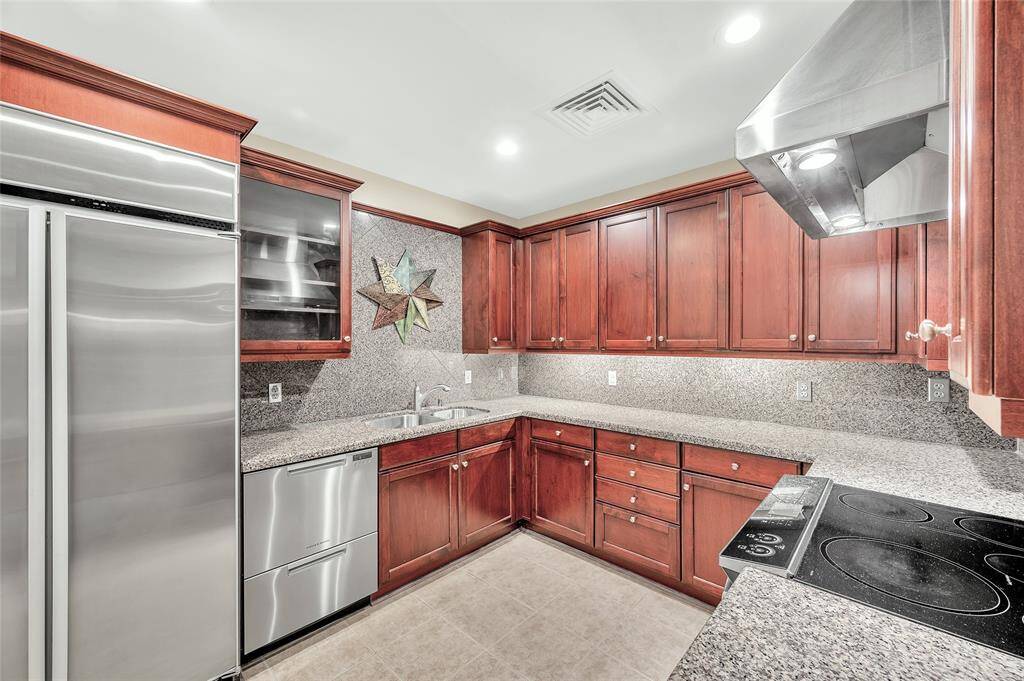 This spacious Kitchen is not your typical condo tiny Kitchen. Abundant storage in Brookhaven cabinetry with granite countertops & backsplash. There is also a Walk-In Pantry. Sure to please the Chef or Foodie in your home!
