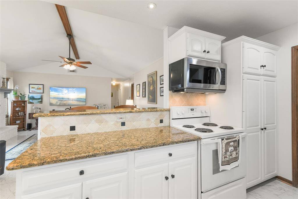 The open bar seating area seamlessly connects to the living space, making it perfect for entertaining.