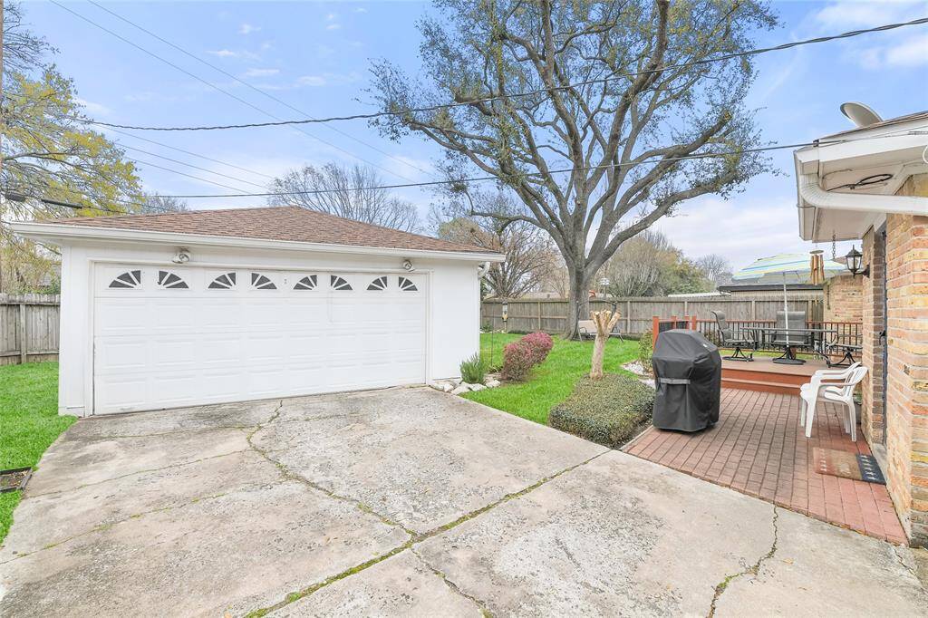 This versatile outdoor space offers a large detached garage with ample storage, perfect for vehicles, a workshop, or additional storage needs. The extended driveway and patio area provide a great space for outdoor gatherings, barbecues, or simply relaxing in the fresh air.