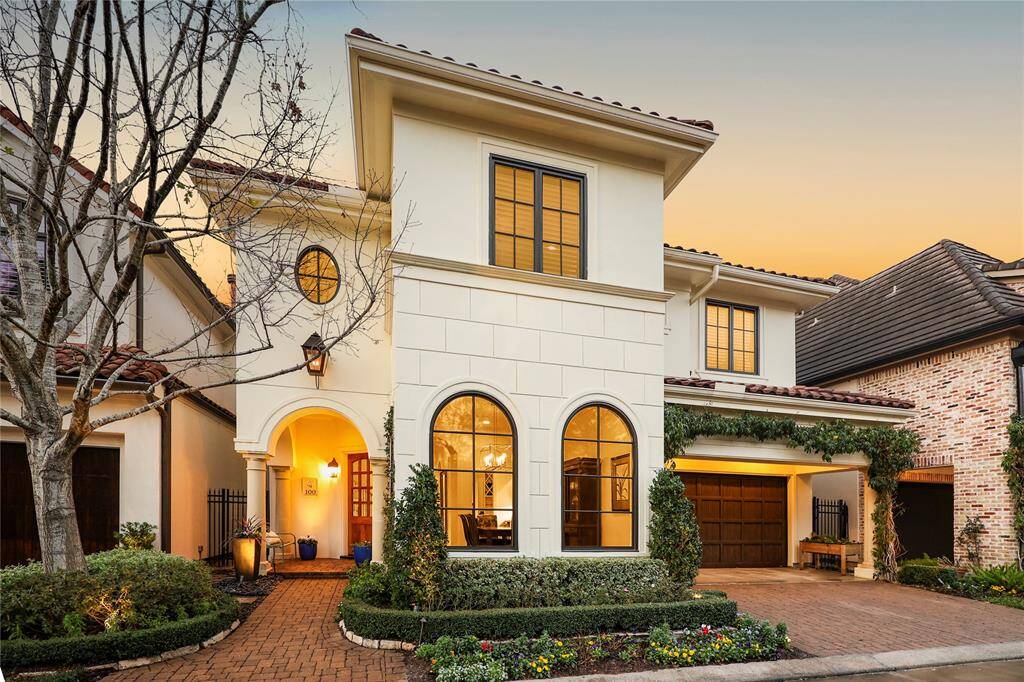 A charming brick pathway, bordered by lush, manicured landscaping, guides you to the inviting front porch. The solid wood door opens to a welcoming foyer, seamlessly connecting to the thoughtfully designed first-floor living areas.