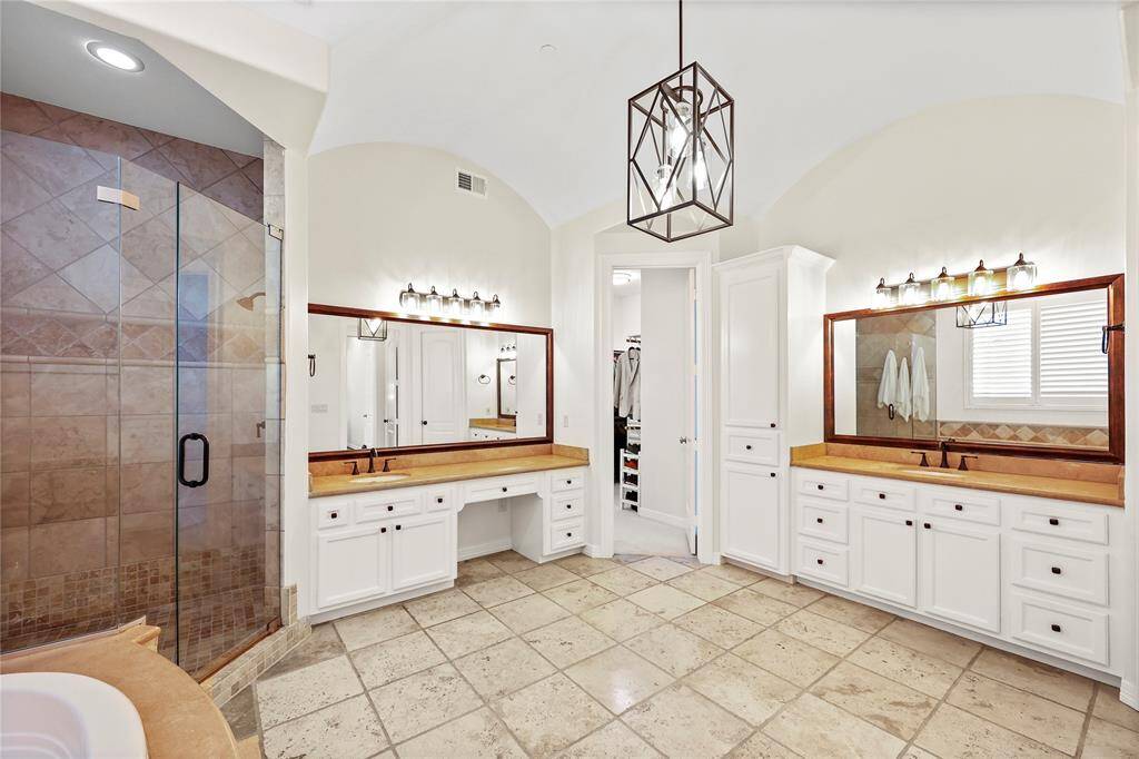 Enjoy the luxury of a large jetted soaking tub,a spacious walk-in shower with frameless glass door, and dual vanities.