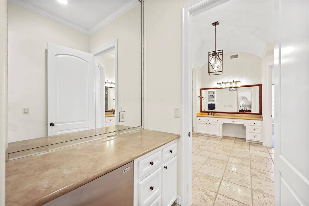 The spacious primary features an extended vanity with ample counter space