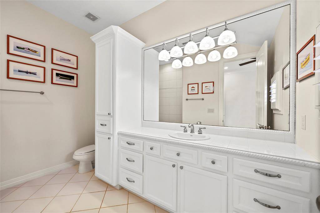 Ensuite bath features an expansive vanity w/tile counter and vanity lighting