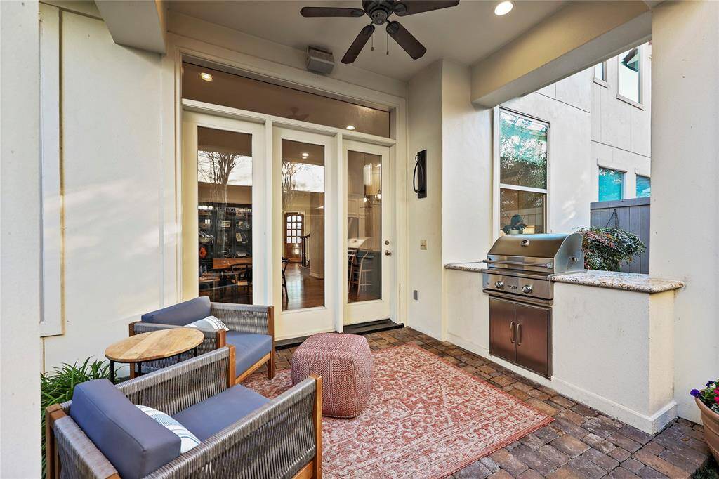 Relax and entertain in the covered patio, offering picturesque views of the lush gardens and tranquil fountain. Complete with a built-in grill, this inviting outdoor space is perfect for al fresco dining and gatherings with guests