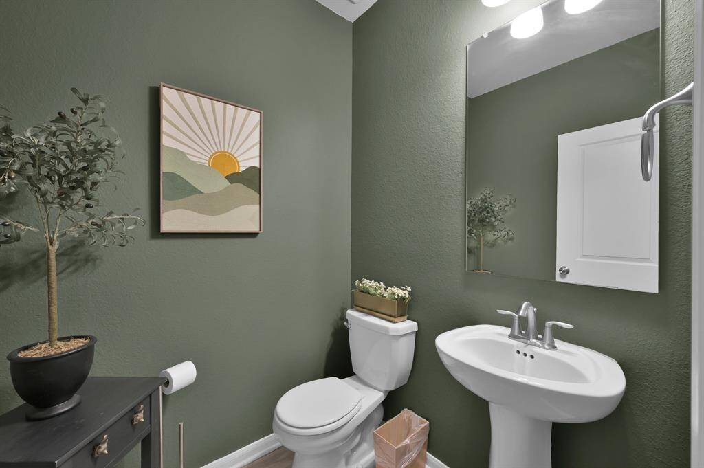The downstairs powder bathroom, also accented with green walls.