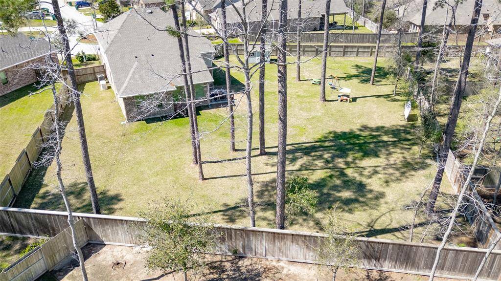 A view of the yard from behind. We see plenty of space for a garden, pool, etc. Whatever your heart dreams up!
