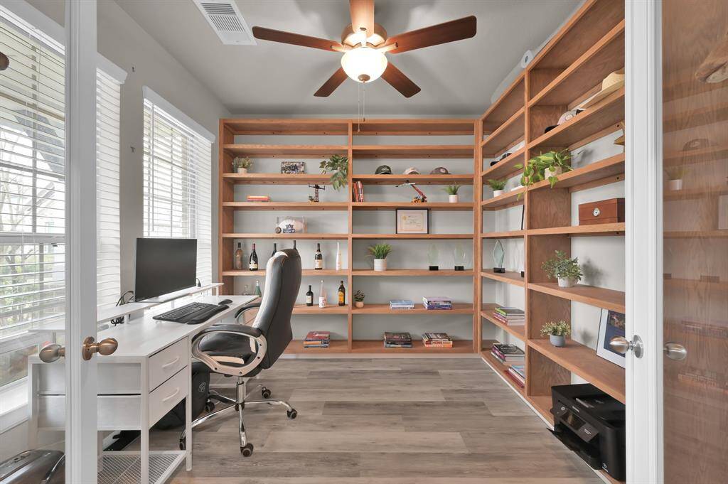 The home office features large built-in shelving, perfect for all your office and work supplies.