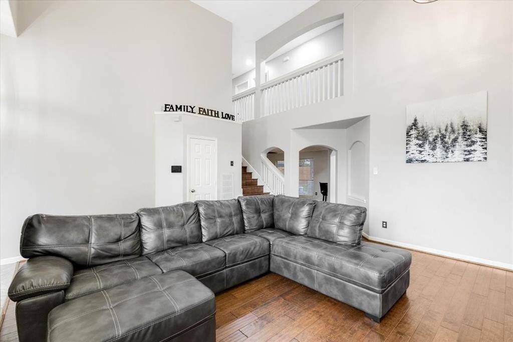 This living room features high ceilings and an open layout, creating a spacious feel.