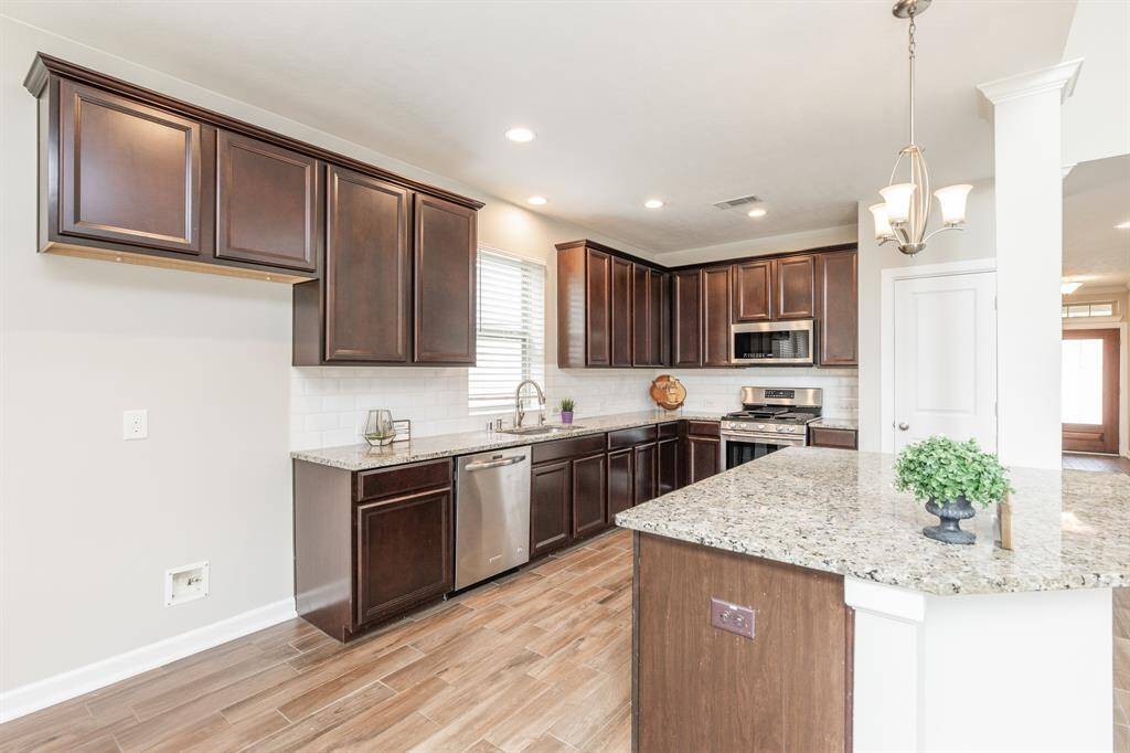 The kitchen boasts granite countertops and fresh repaint cabinet.