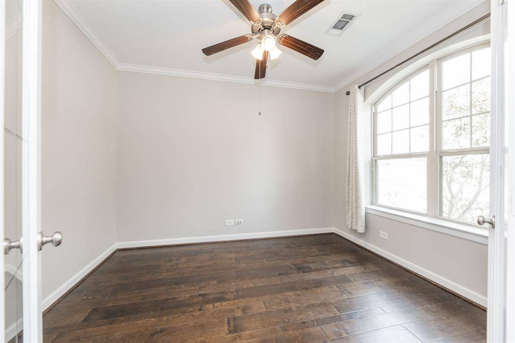 To the right, you'll find office with wood flooring and glass French door.