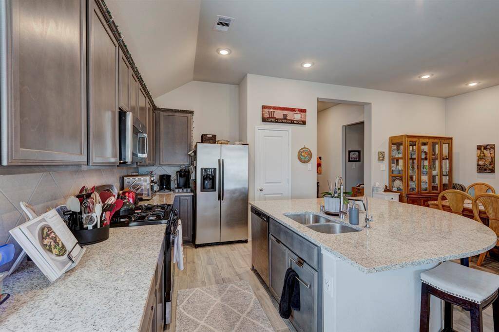 Kitchen offers a breakfast bar, and sits right next to the dining area.
