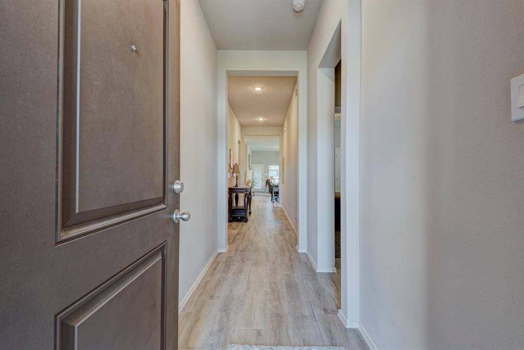 Walking in, you will be greeted with tall ceilings and wood look tile that extends throughout the home.